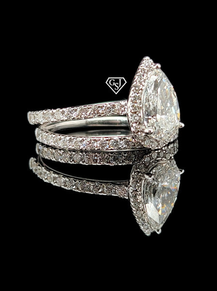 14K gold wedding set features a 1.17CT pear shaped center diamond
