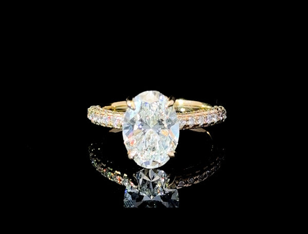 “Feast your eyes on this stunning 3.87 carat total diamond weight lab-grown Oval diamond engagement ring. Set in luxurious 18kt yellow gold, this show-stopper is guaranteed to turn heads at any occasion.”