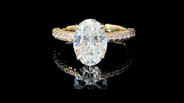 “Feast your eyes on this stunning 3.87 carat total diamond weight lab-grown Oval diamond engagement ring. Set in luxurious 18kt yellow gold, this show-stopper is guaranteed to turn heads at any occasion.”