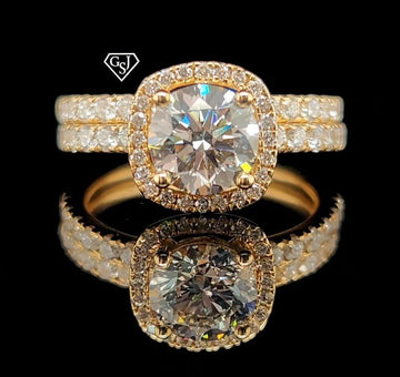 features a stunning 1.26CT center stone! Set in 14K Gold, this set is sure to impress